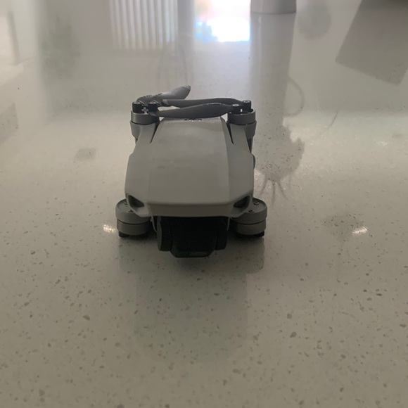 DJI Mavic Mini drone with storage case controller and connecting cords.